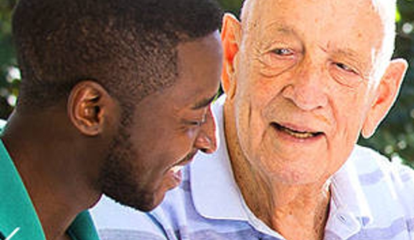 Amana Living - Subiaco, WA. A resident and his carer outdoors