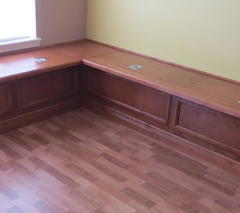 Borders Woodworks - Jacksonville, FL. Custom stained alder banquette with storage compartments
