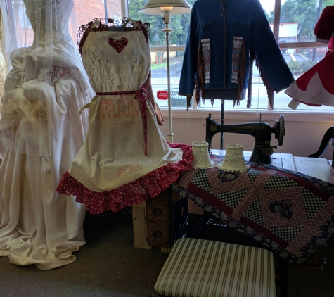 SilverWing Sewing & Alterations - Hamilton, OH. Vintage Treadle sewing machine as part of window display.  Apron featured was made from Vintage feed sack.