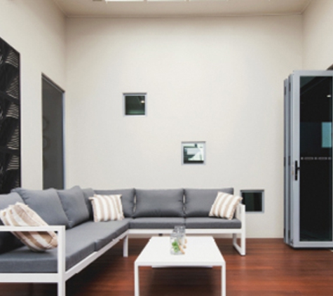 Bradnam's Windows & Doors - Mount St John, QLD. Ultra Silver Aluminium Bi-Fold Door With Grey Glass
