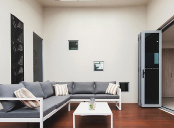 Bradnam's Windows & Doors - Urraween, QLD. Ultra Silver Aluminium Bi-Fold Door With Grey Glass