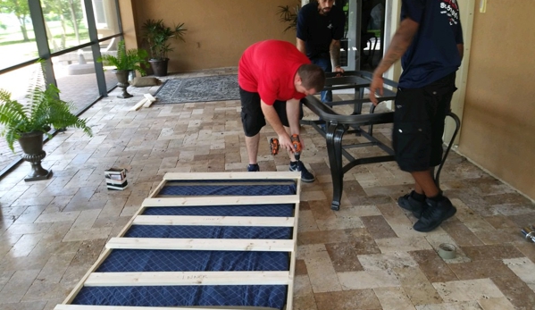 Americas Movers Inc. - Miami, FL. Our professional movers building a crate for a marble top table.