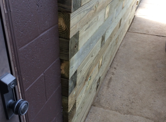 Beaver Valley Lawn Service - Aliquippa, PA. The brown block foundation wall is plum, the retaining wall is 3 1/2 inches out