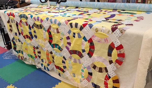 Teresa's Quilting Studio - Merryville, LA. Hand pieced antique Double Wedding  Ring top being finished at last