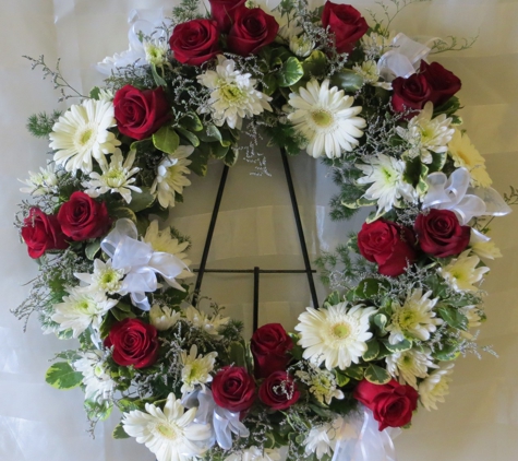 Pitkin Sympathy Florists & Gift Baskets - Brooklyn, NY. funeral wreath. Flowers include traditional red roses along with white gerbera daisies and sheer white bows placed together are a great way