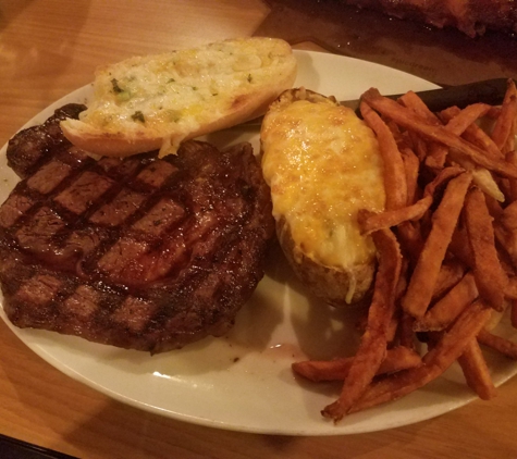 Jaspers Smokehouse & Steaks - Big Bear Lake, CA. delicious ribeye with twice baked potato, cheesy bread and sweet potato fries