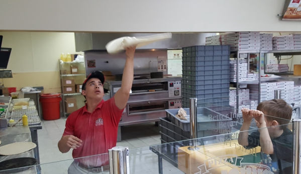 Papa Johns Pizza - Anchorage, AK. Employee asked if wanted to watch him throw some dough. Thought it was pretty neat.