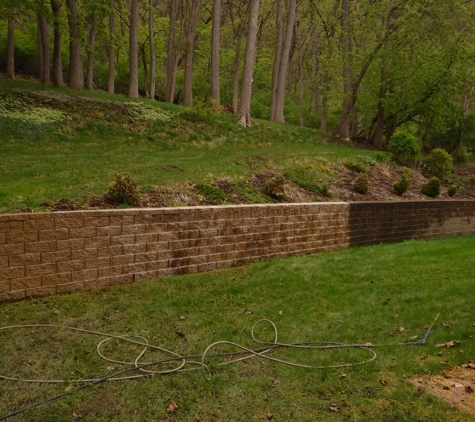 RDP Clean - Saint Charles, MN. Retaining wall. Left side before. Middle soaking. Left done.