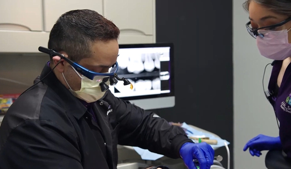 Ahh Smile Family Dentistry - Laredo, TX. Laredo dentist Dr. Johnny Cavazos working on dental implants procedure at Ahh Smile Family Dentistry