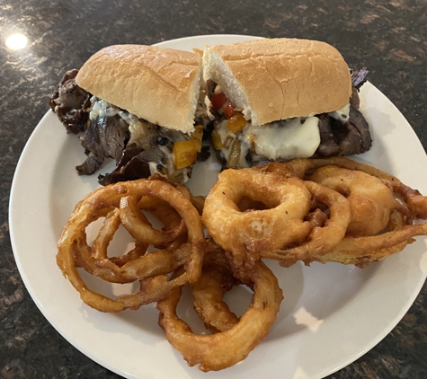 Floaters Pub - Big Lake, AK. Philly Cheese steak with hand dipped onion rings