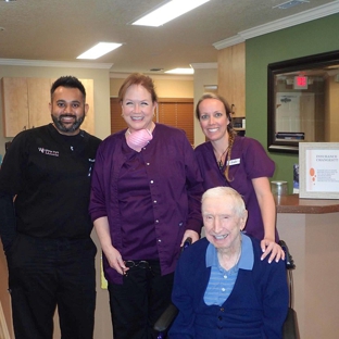 Winter Park Dental - Winter Park, FL. Winter Park dentist Dr Mainak Patel with his team and happy dentures patient at Winter Park Dental