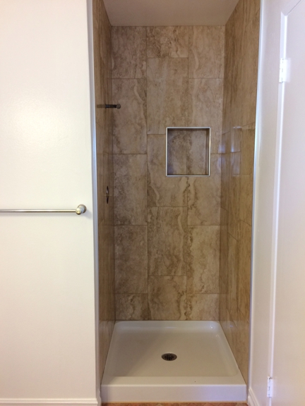 A Dan The Handyman - Santa Ana, CA. After bathroom remodel with new valve, new shower pan, new porcelain walls. Door to be installed soon.