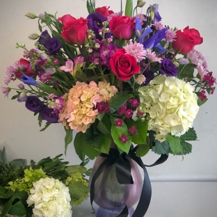 Garlands of Grace - Palmer, AK. Bursting with roses and hydrangea, this arrangement will bring beauty to any occasion.