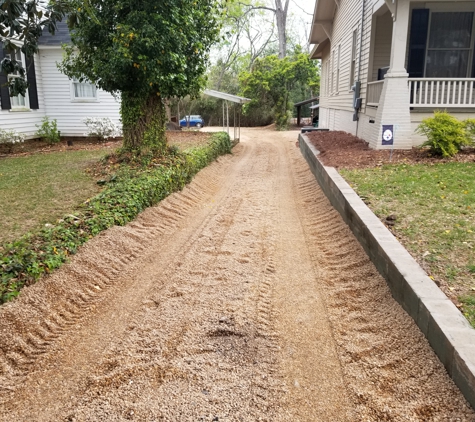 Elite Lawn Maintenance - Albany, GA. Excess gravel pushed to the side walls of the driveway