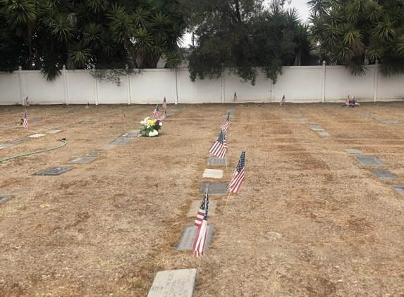 Lincoln Memorial Park Cemetery - Carson, CA. The ground is hard as a rock. Had to place fake flowers