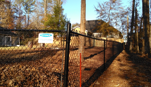 Exterior Fence Builders  Inc. - Lawrenceville, GA. Black vinyl coated chain link fence installation Cumming Ga.