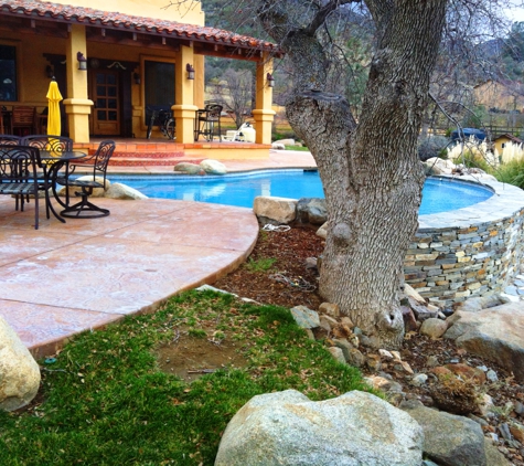 Rock Bottom, Inc. - Bakersfield, CA. Pool with rock retaining wall