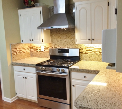 Granite Transformations of Little Rock - North Little Rock, AR. This Kitchen received a new range hood, gas oven and stove, new quartz and granite counters and backsplash with glass and tile inlay!