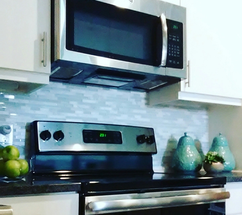 LRK Decor - The Colony, TX. Loving this glass mosaic tile backsplash with these white cabinets. So crisp and clean, it has an air of freshness about it.