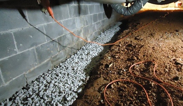 Harris Waterproofing & Construction, Inc. - Lilburn, GA. Drain is under the gravel along the interior foundation wall of crawlspace