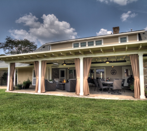 ABC Home Improvements - Baton Rouge, LA. Outside view of a covered patio with open curtains | Custom Patio Cover Arbor in Baton Rouge - www.lasunrooms.com