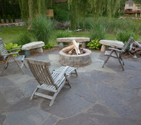 Botanical Designs and Landscaping Inc. - Lake Orion, MI. rock benches - 20 people seating around fire pit