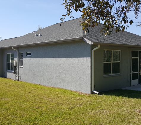 Paramount Seamless Gutters - Beverly Hills, FL. Left side of  house with gutter tucked between other utilities  to make a clean line along house