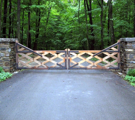 Tri State Gate - Bedford Hills, NY. Natural weathered wood trellis-style driveway entry gate by Tri State Gate, Bedford Hills, New York