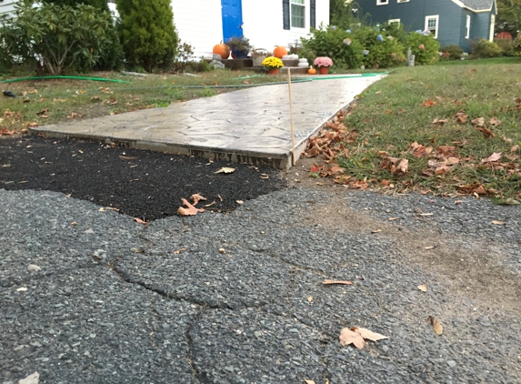 Spartan Concrete Services Inc - Wilbraham, MA. yes, the entire beginning of the walkway has a 2" step up.  It's a hazard and not what we were told we would be getting. :(