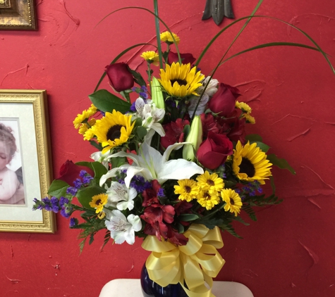 A Touch Of Class Florist - Vestavia, AL. Fall is in the air. Bright fall color mix of sunflowers lilies roses and alstomerias.