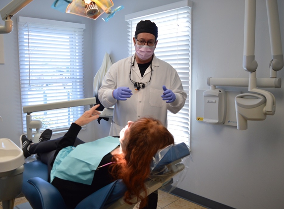 Banker Dental Associates - A Dental365 Company - Elizabeth, NJ. Elizabeth dentist Dr. Joseph Banker interacting with implant supported dentures patient