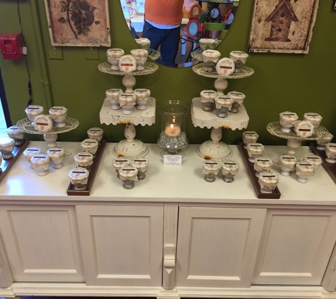 Vivid Boutique - Decatur, GA. Beautiful hand poured scented Nouvelle candles in a variety of ceramic urns and colors