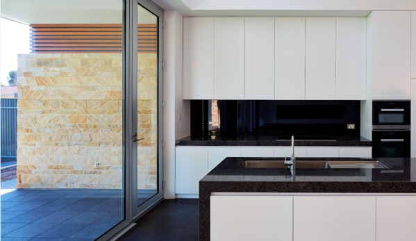 Qbic Living - Parkside, SA. Satin doors with granite benchtops, splashback & integrated appliances