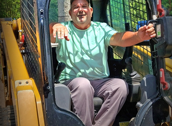 Four Oaks Residential - Four Oaks, NC. Masonry supervisor enjoying a little time on the new skid loader.