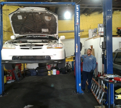 The Fix Car Care Clinic - Philadelphia, PA. Raising car to perform oil change