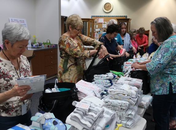 Assistance League Thrift Shop - Reno, NV. Stuffing bags for veterans with children