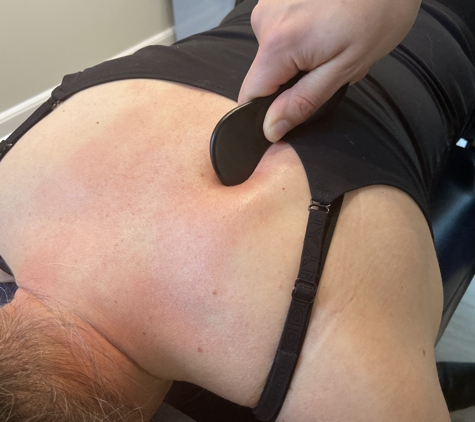 Seven Bridges Chiropractic - Jacksonville, FL. Instrument Assisted Soft Tissue Manipulation being performed on a patient