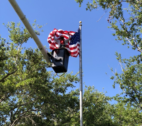 Tree service inc - Royal Palm Beach, FL. Trimming trees away from old glory making sure she could fly!!!