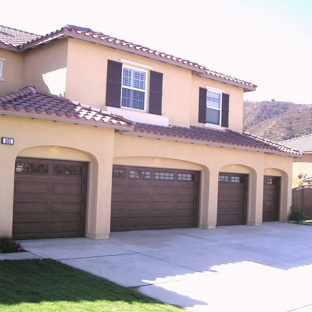 Sparkle Restoration Decorative Concrete Resurfacing - Corona, CA. Wood faux finish garage doors, matching existing wood gate. Maintenance-free!