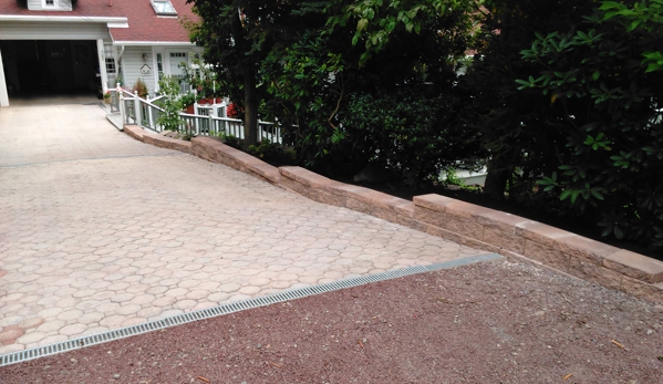 Powell's cutting edge landscaping - Wilkes barre, PA. Removed old wood retaining wall installed new Terrence wall.