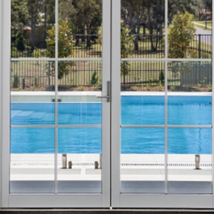 Bradnam's Windows & Doors - Emerald, QLD. White Aluminium Hinged Door With Colonial Bars