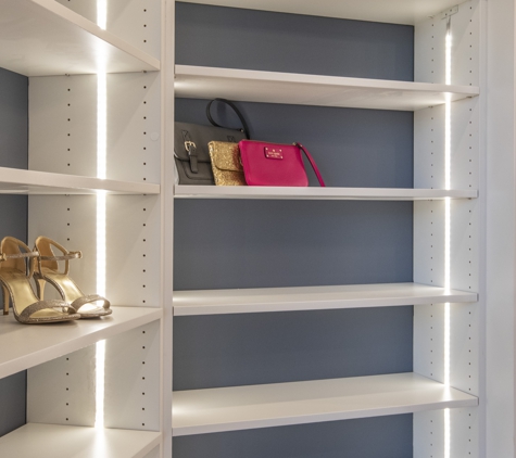 Bella Systems Philly. White walk in custom closet with shaker fronts and center island.  Shoe units with LED lighting.