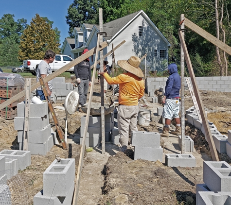 Four Oaks Residential - Four Oaks, NC. Masonry crew moving the corner poles to a new wall  section.