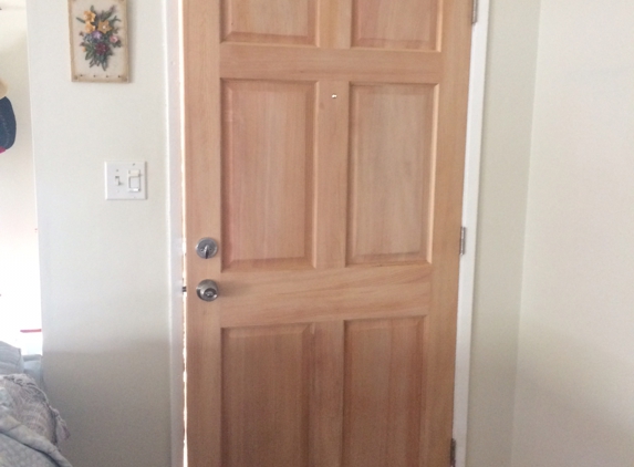 A Dan The Handyman - Santa Ana, CA. New wood door installed, happy homeowners.