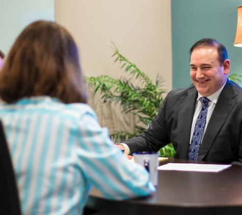 Outlook Wealth Advisors - Houston, TX. Michael Neuenschwander, CPA, CFP® meting with Outlook Wealth Advisor clients to discuss their retirement tax and income strategy.