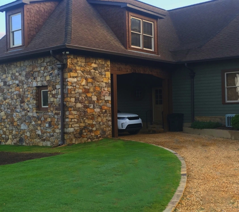 DSLD Land Management - Birmingham, AL. installed a moss rock veneer on house. and installed edging stone with selma brown gravel for driveway.