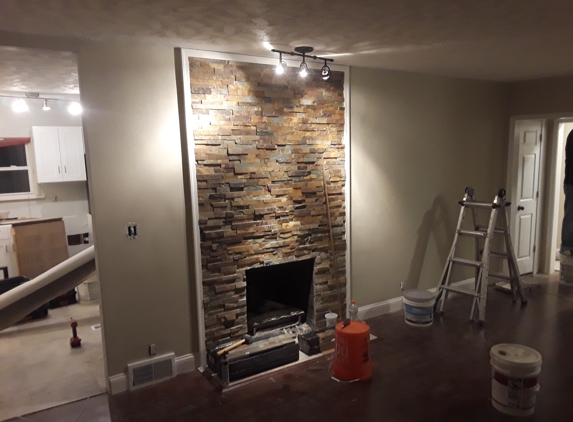 Absolute Interiors and Design, LLC - Cleveland, OH. Stacked stone facing to give an old fireplace a modern look