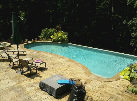 Atlantis Pools & Spas - Gaston, SC. Negative edge gunite pool, stamped concrete