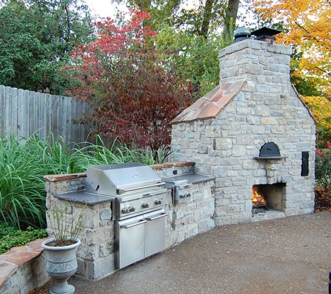 French Masonry - Imperial, MO. White stone fireplace, natural stone outdoor kitchen, backyard bbq, patio, wood fire pizza oven.