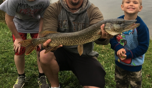 Greenwood Acres Campground - Jackson, MI. Camping dad with his sons and a big, pike caught off shore.